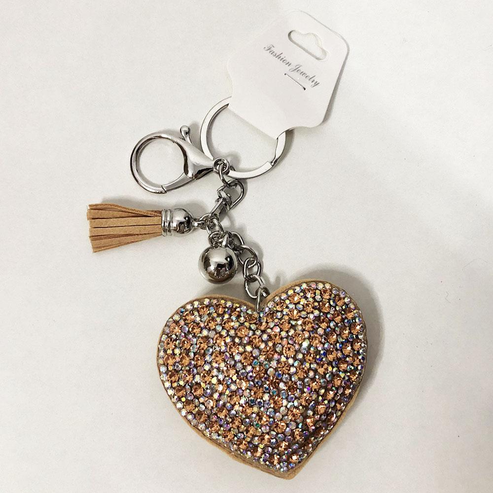 Брелоки із замші блискучі в формі серця. Колір бежевий